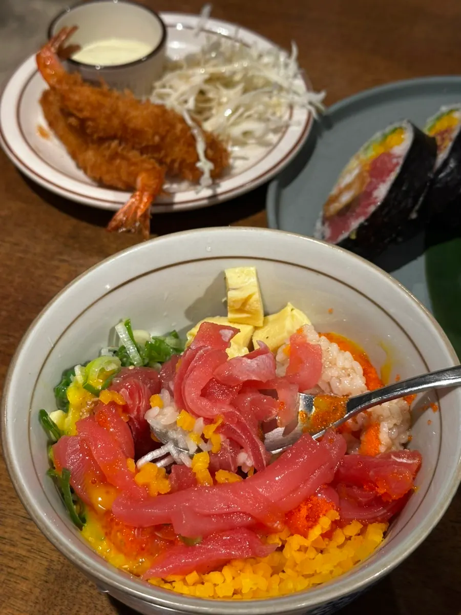Tuna rice bowl mixed with a broken egg yolk