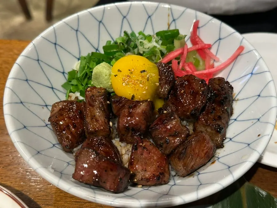Steak rice bowl topped with grilled flank steak
