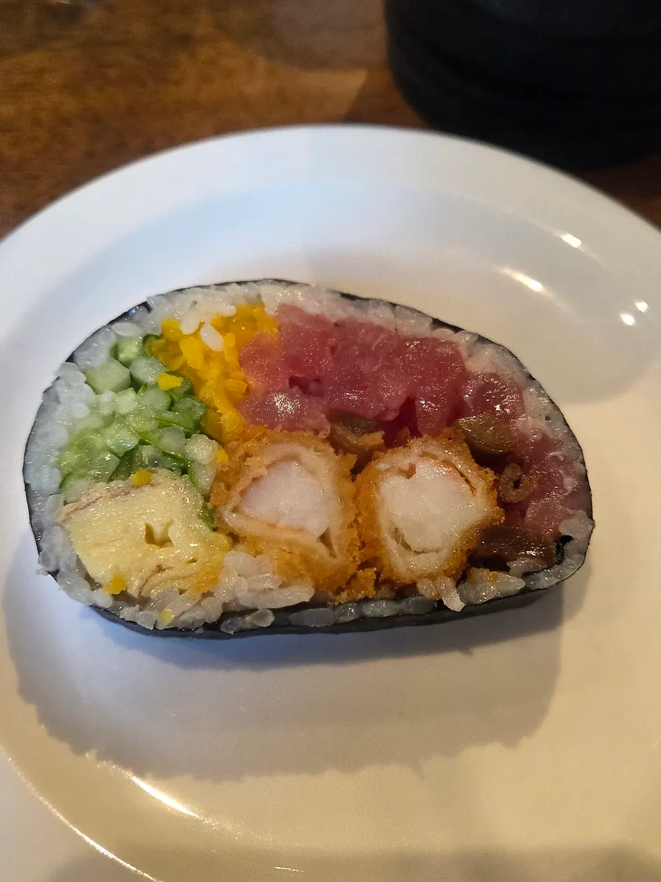 A piece of futomaki cut with scissors
