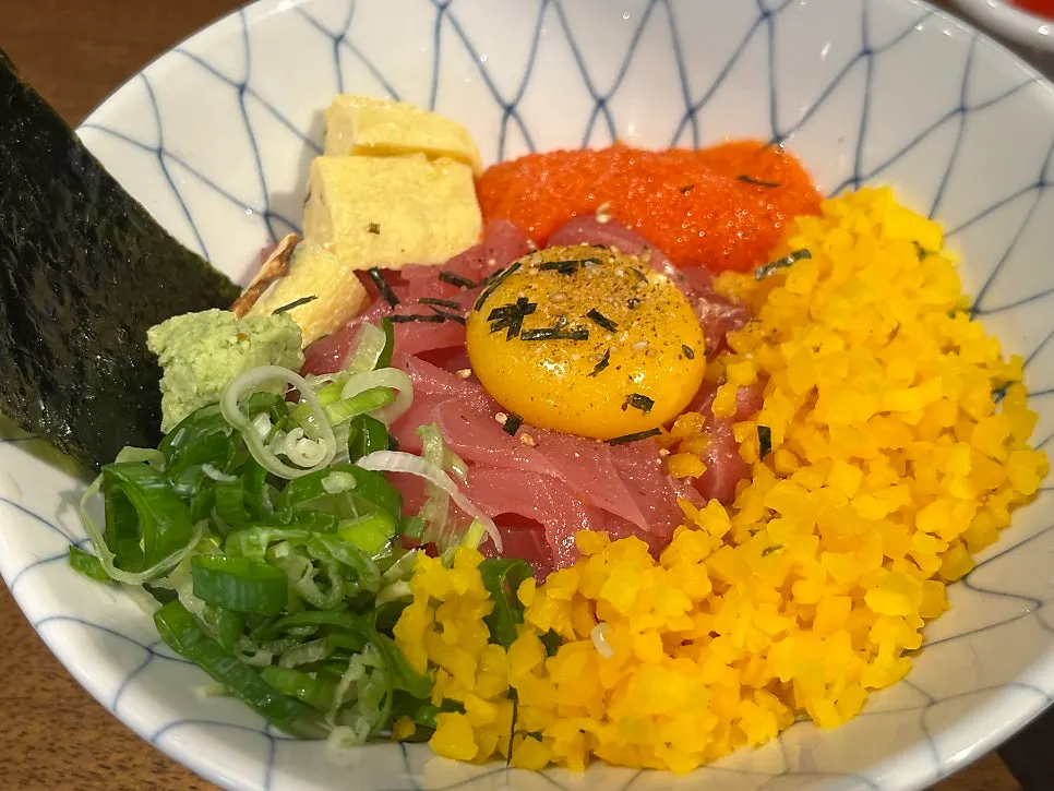 Tuna rice bowl topped with tuna and egg yolk