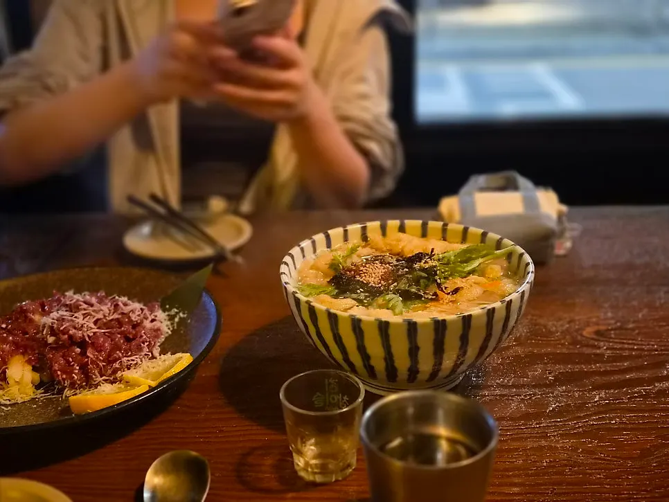 Drinking snacks and glasses on a window-side table at Jeongju Ilga