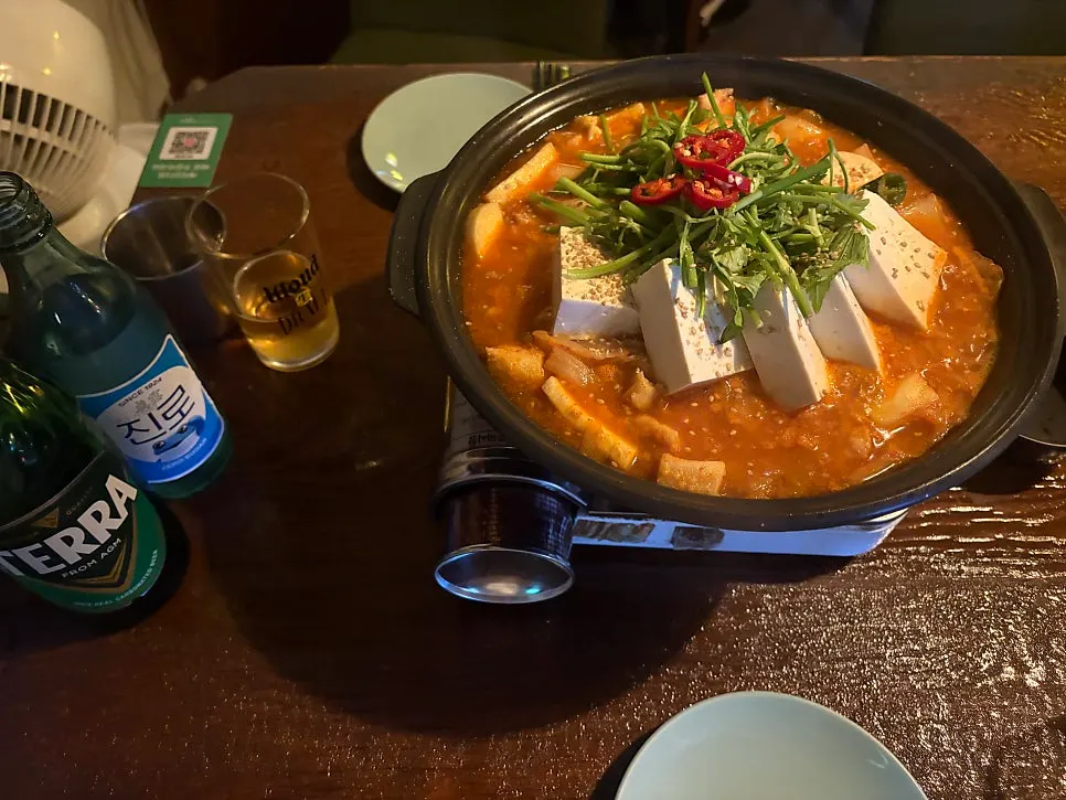 Pork kimchi jjaglee served with a burner on the table