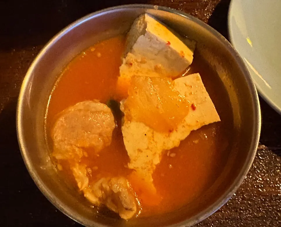 Pork kimchi jjaglee broth topped with tofu