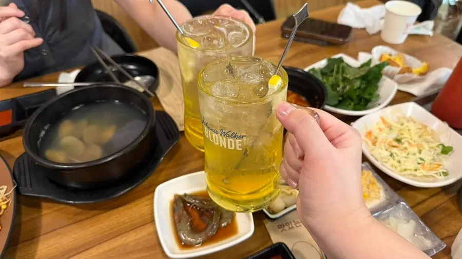 Toasting a highball alongside the banchan