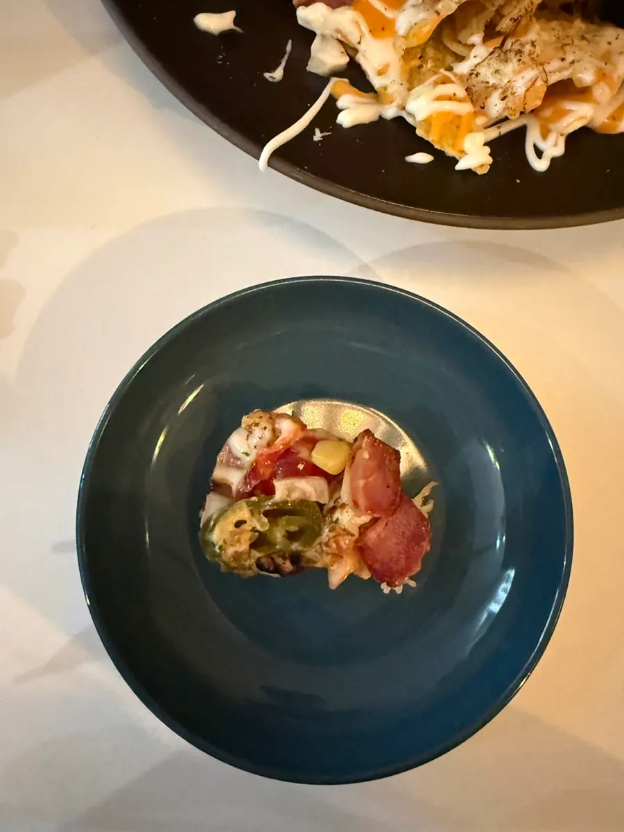 A spoonful of nachos piled high