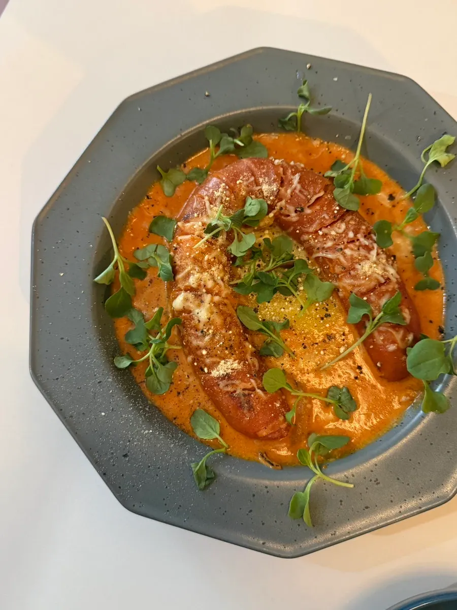 Kielbasa in Hell sitting on red sauce