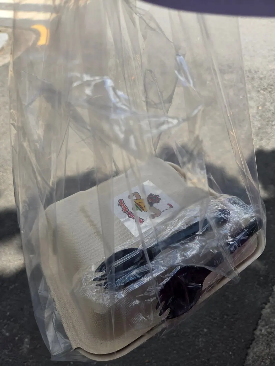 Macho Nacho takeout container packed with a fork and spoon