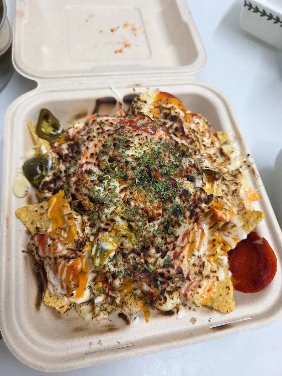 Pepperoni pizza nachos brought home in their takeout packaging