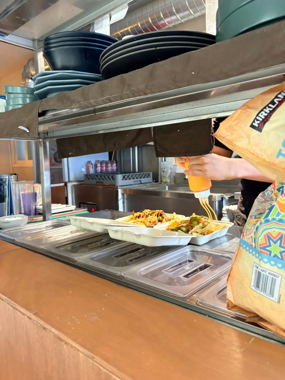 Two ordered nacho dishes waiting to be finished