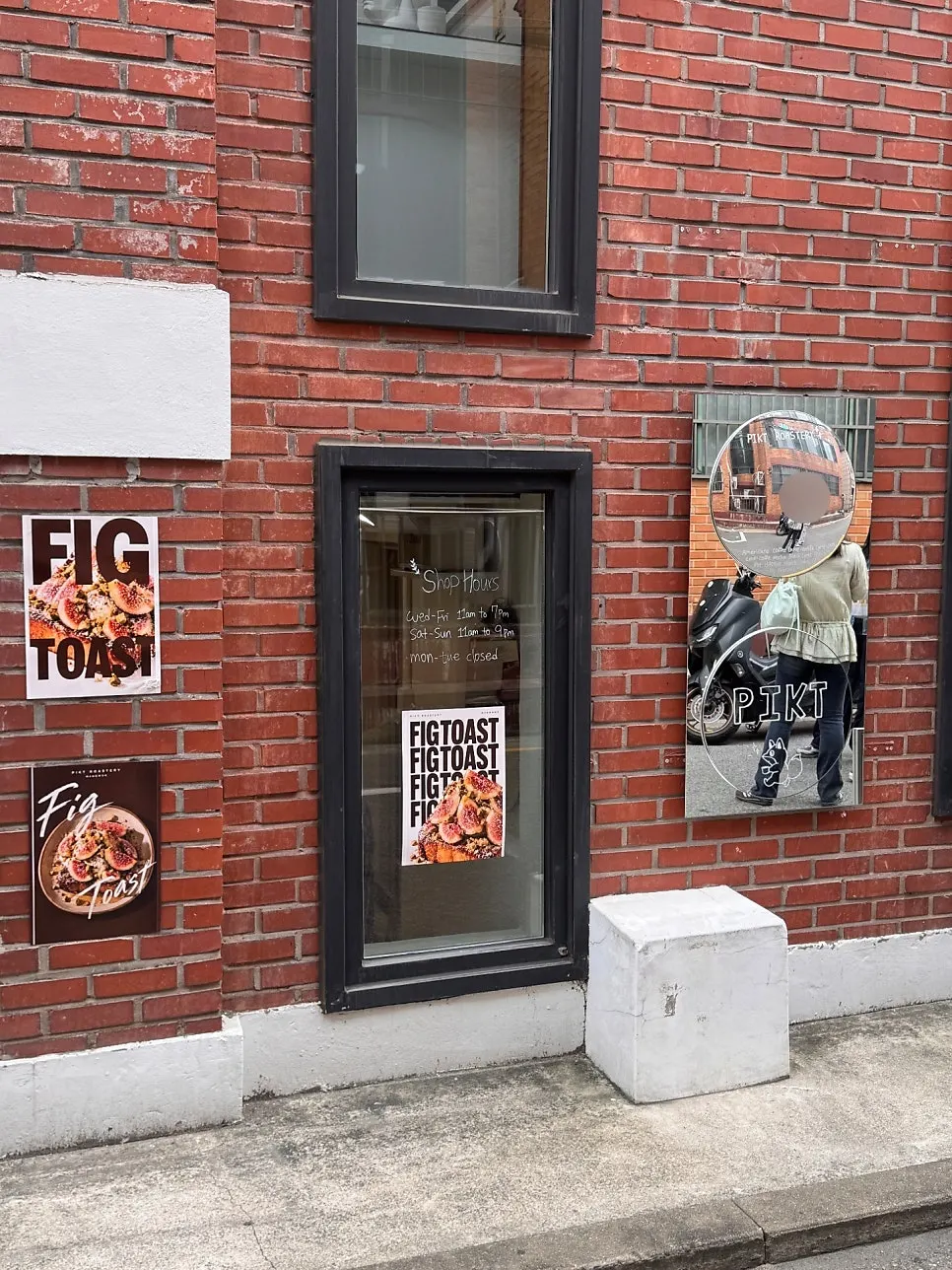 Vertical shot of the café exterior with the interior visible through the picture window
