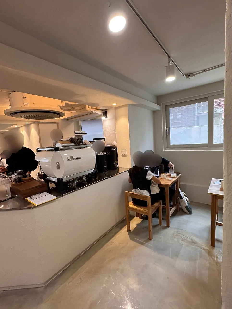 Café interior with ivory walls and wooden tables