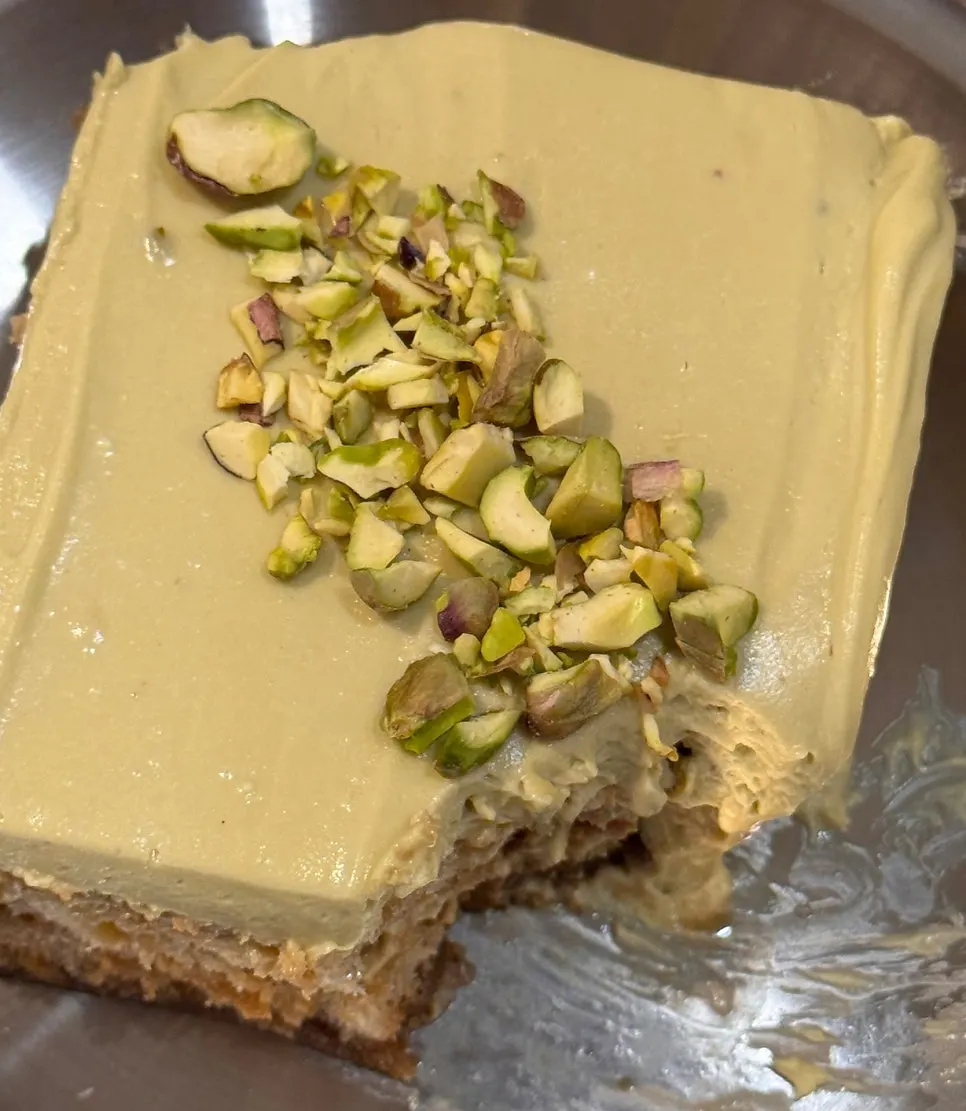 Pale green pistachio cream tiramisu on a silver plate