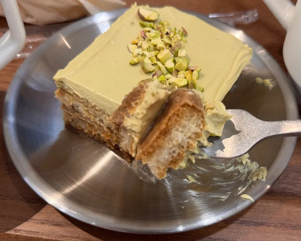 Cross-section of moist tiramisu sponge lifted with a fork