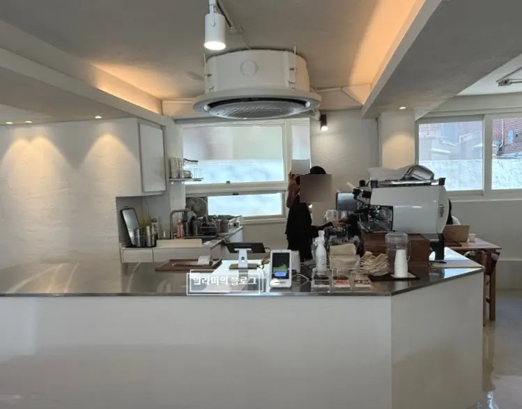 Bright café hall with wood-toned two-person tables