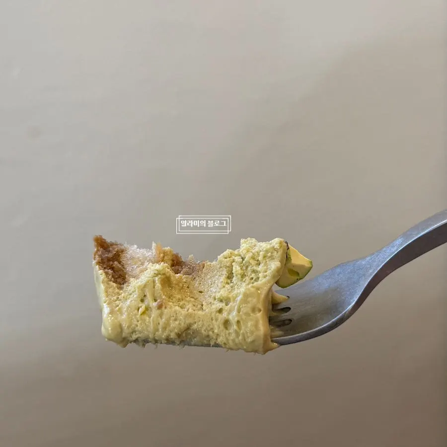 Cross-section of tiramisu showing pistachio cream between the sheets