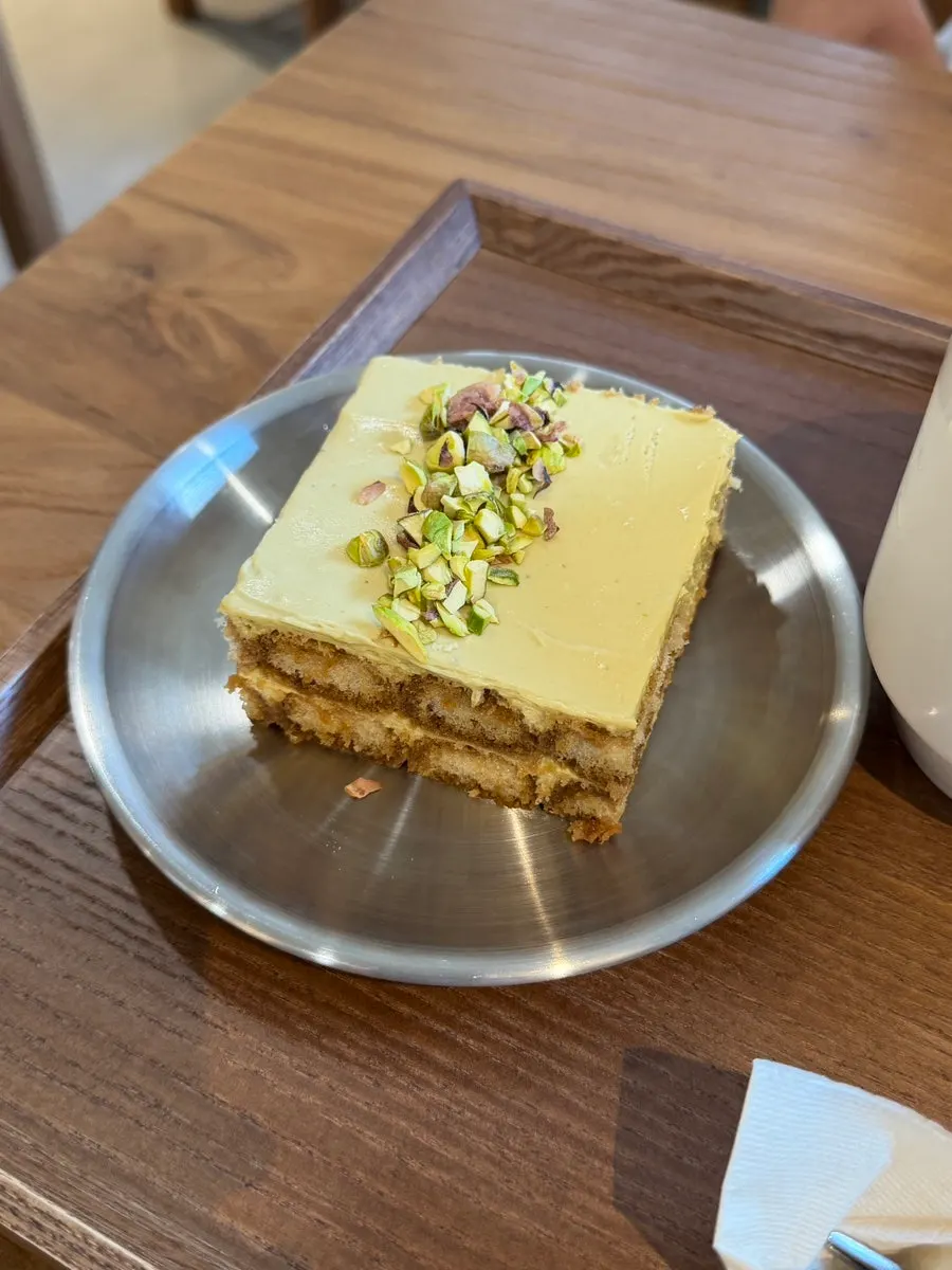 Pistachio tiramisu topped with soft cream
