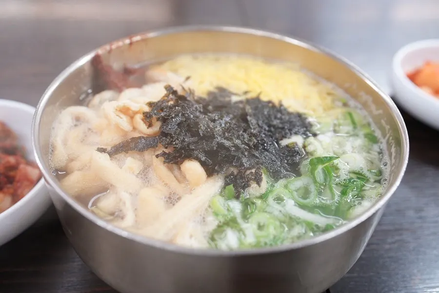 Anchovy kalguksu served with spicy sauce on the side
