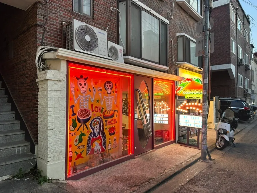 Taco Dot's exterior and neon sign in a Mangwon-dong alley