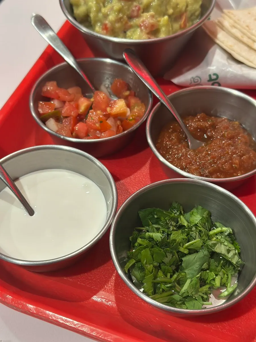 Four meats and sauces on the fajita platter