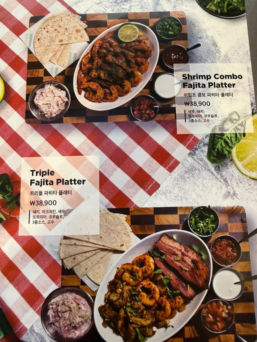 Menu board showing taco options at Taco Dot
