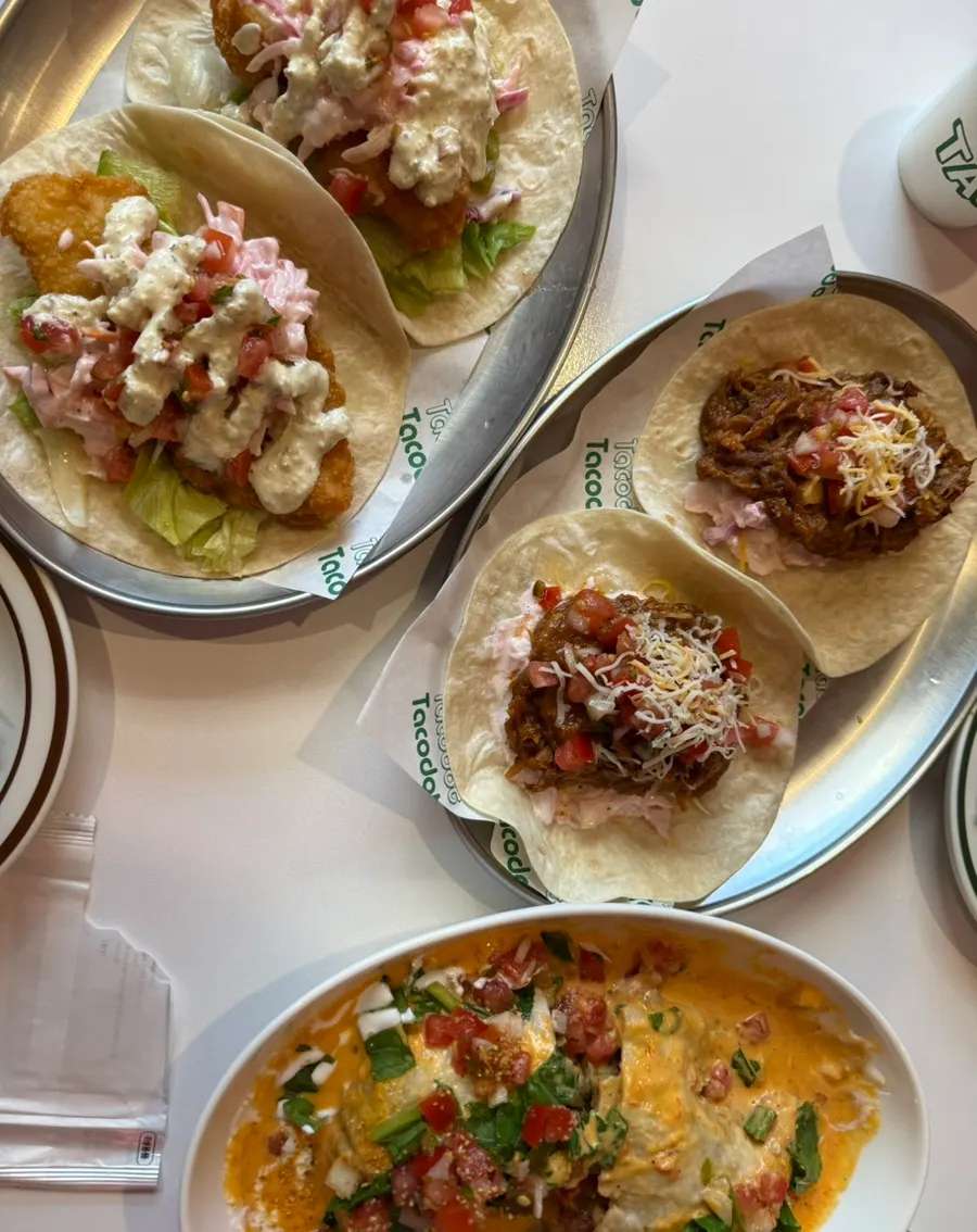 Table with both enchilada and taco dishes gathered together