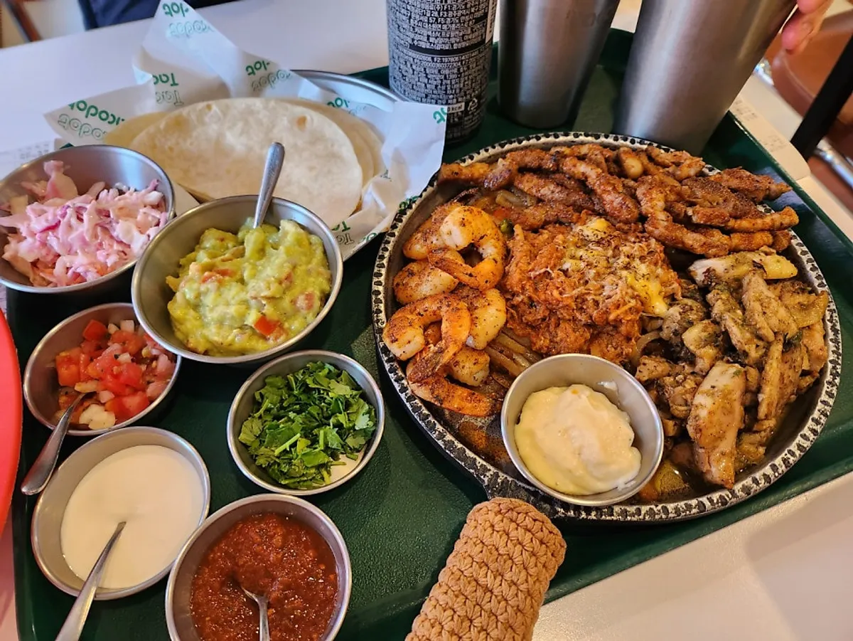Grilled meat fajita platter and accompaniments