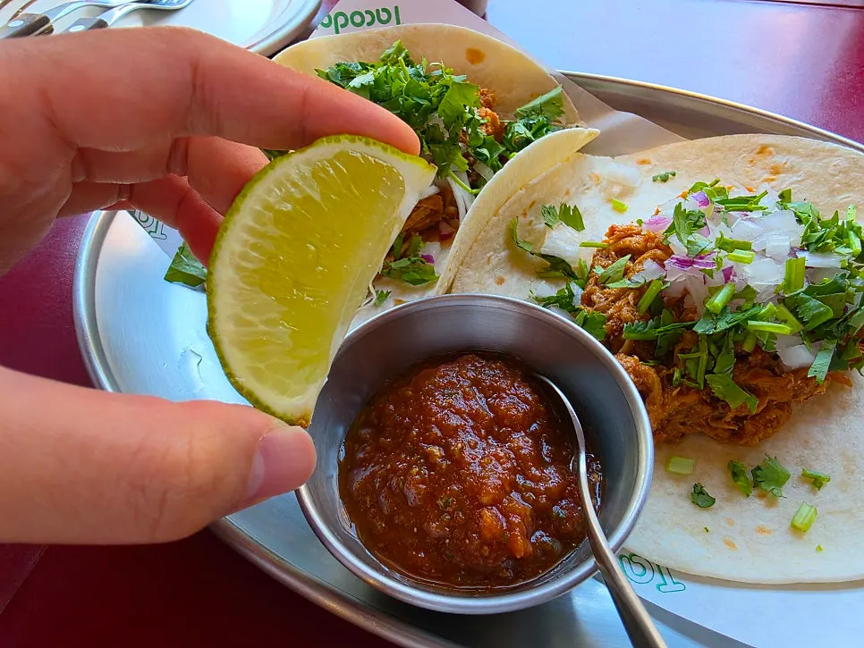 Close-up of finely shredded pork on the carnitas taco