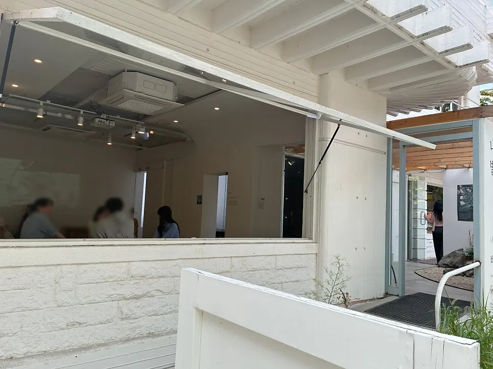 Interior view with wide-open floor-to-ceiling windows