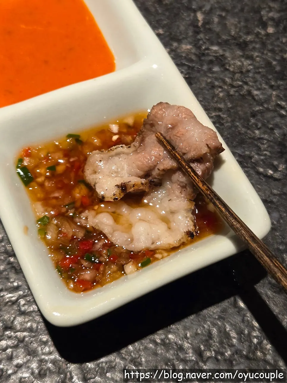 Dipping cooked beef brisket in salt