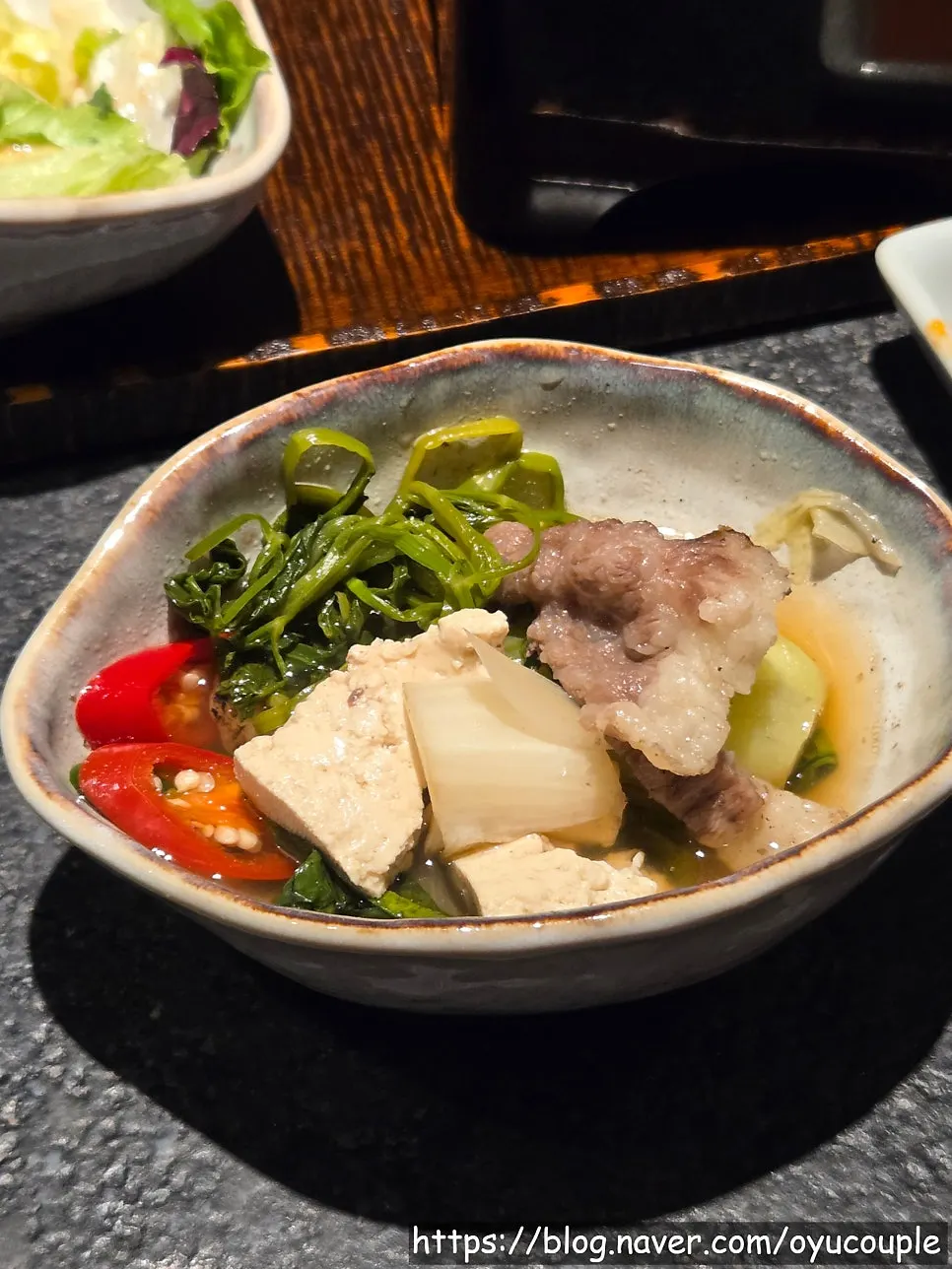 Nabe pot with tofu, mushrooms, and bok choy