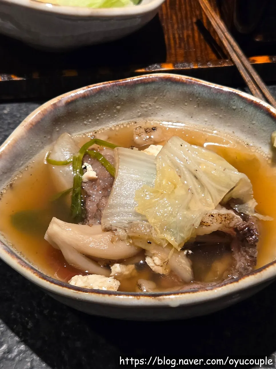 Rich broth simmering in the hanwoo nabe
