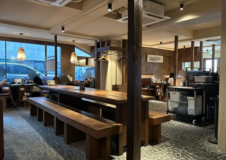 Manmok's interior with low lighting and wood finishes