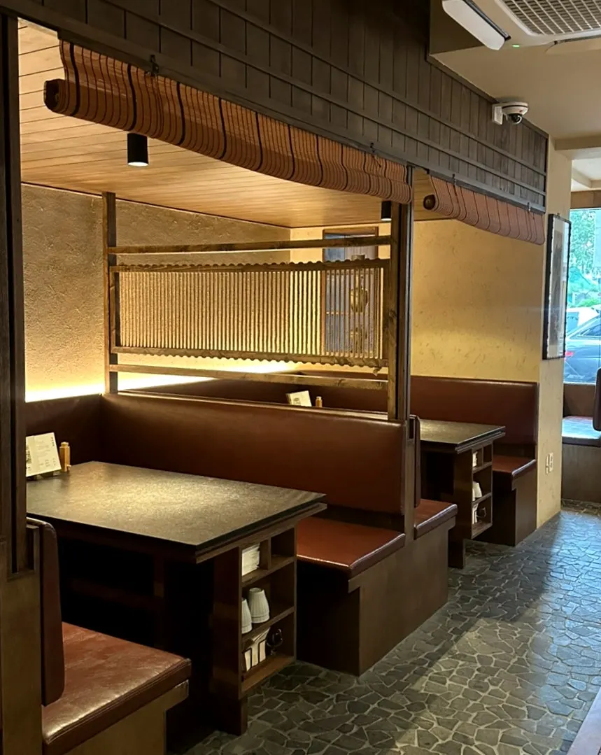 Dark-toned seating inside Manmok