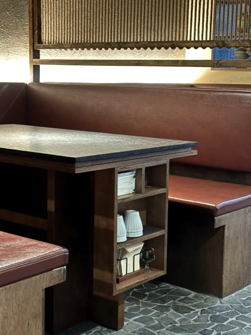 Napkins and cups stored neatly to the side of the table