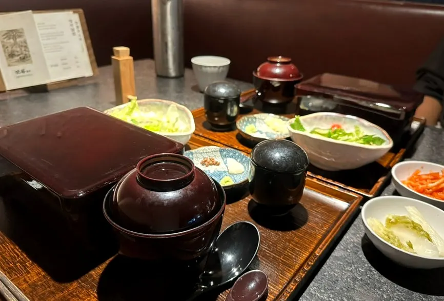 Side dishes served: white kimchi and spicy radish salad