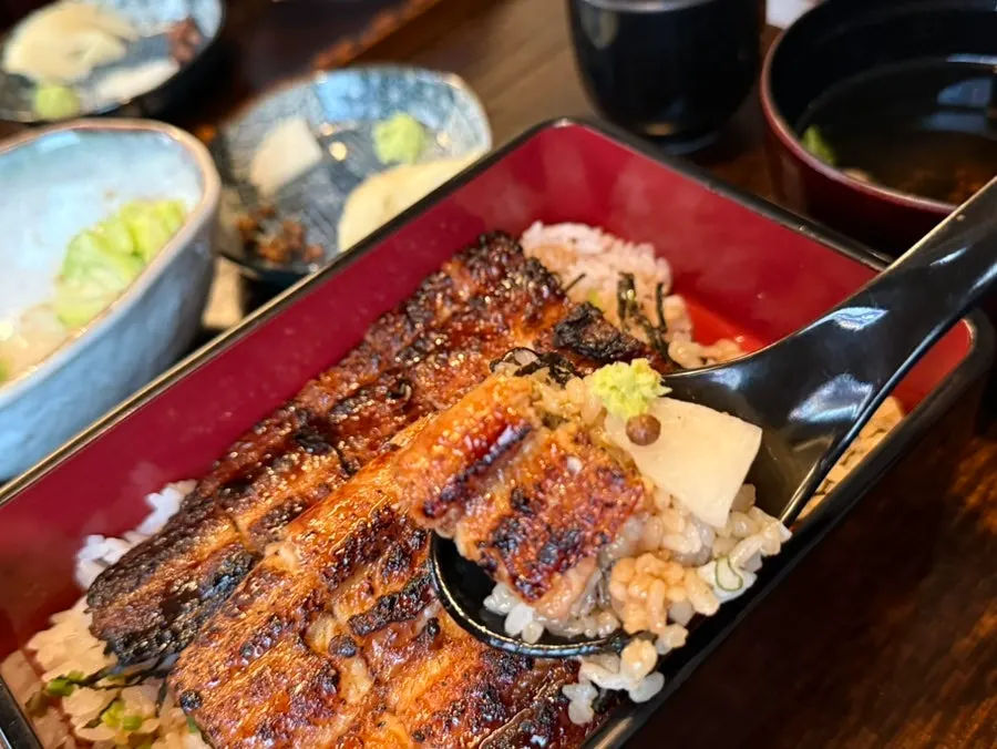 A bite of Manmok's eel rice bowl with wasabi