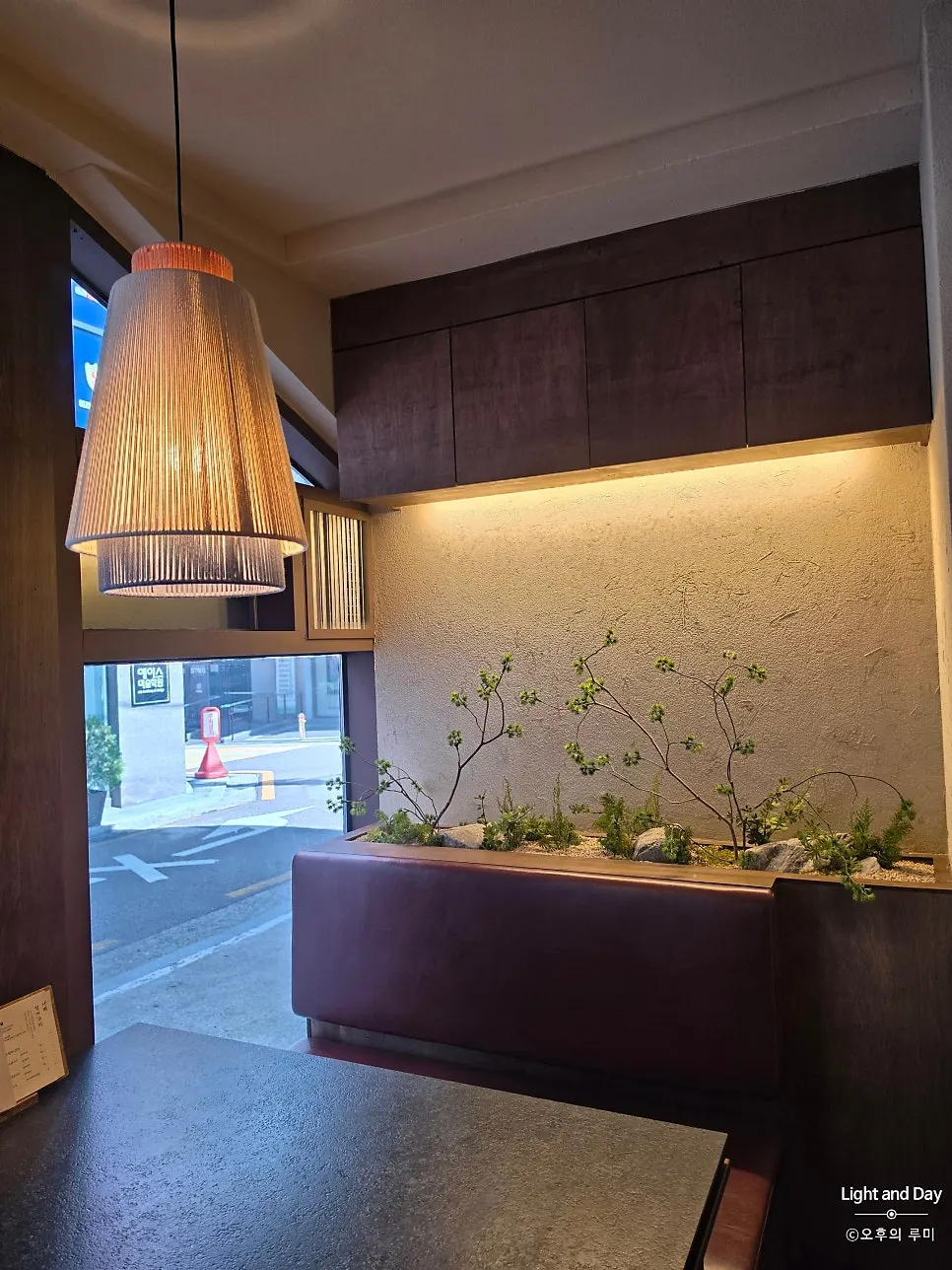 Long wooden table seating inside Manmok