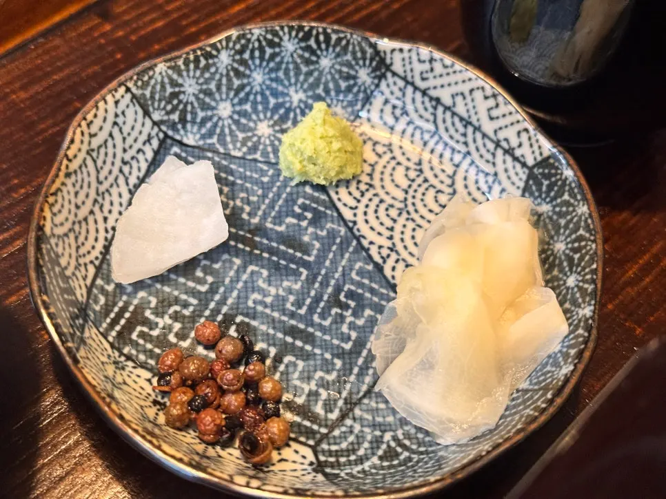 Side dishes: fresh wasabi, pickled ginger, pickled radish, and pickled sansho berries