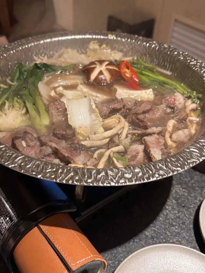 Clear broth bubbling in the hanwoo nabe