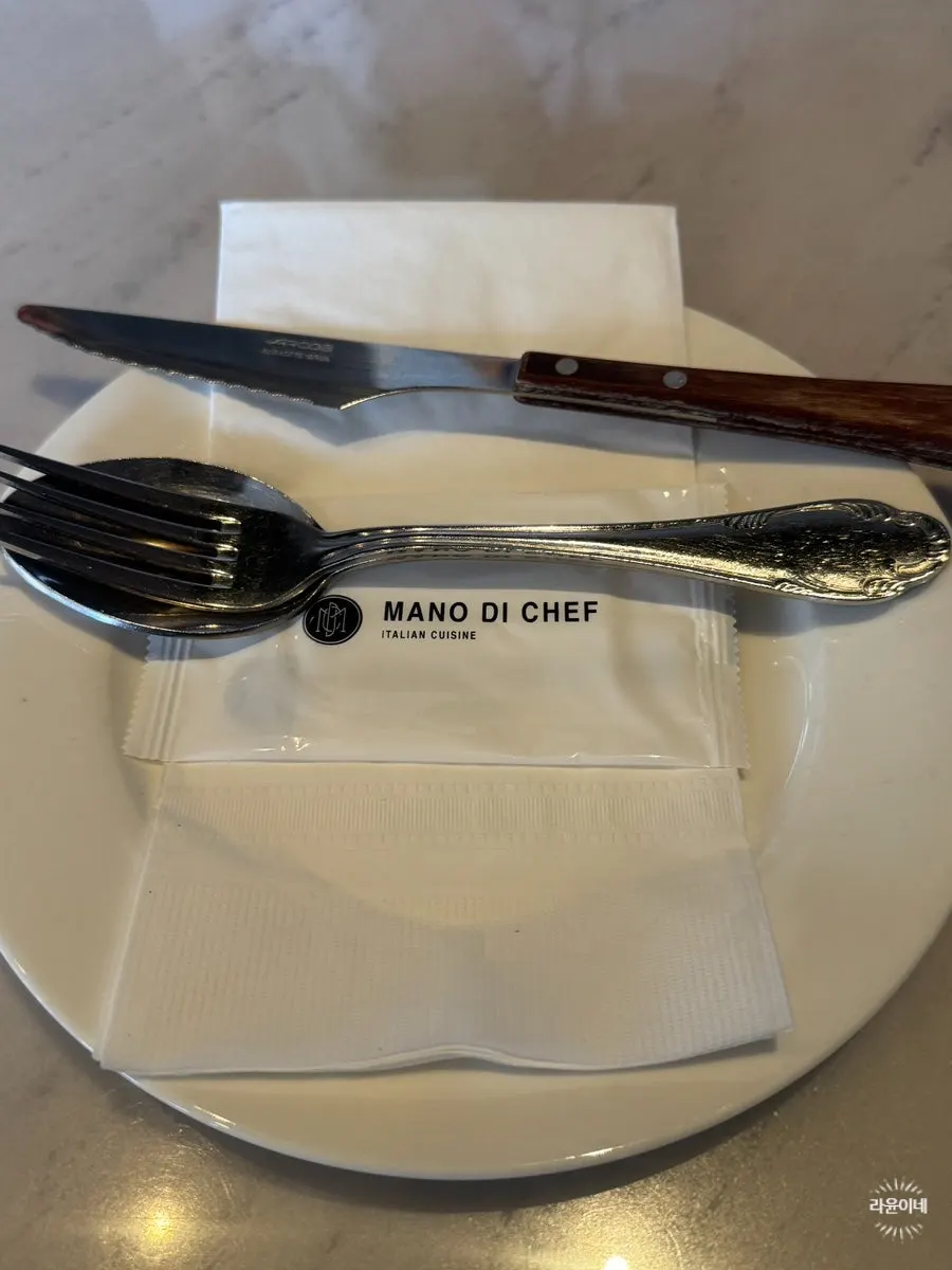 Logo napkin and cutlery set on the marble table
