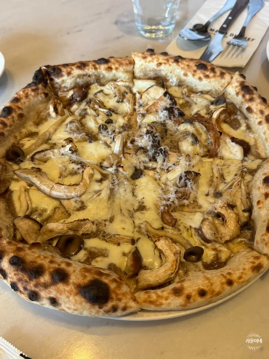 Wood-fired truffle pizza piled with jarasongi mushrooms