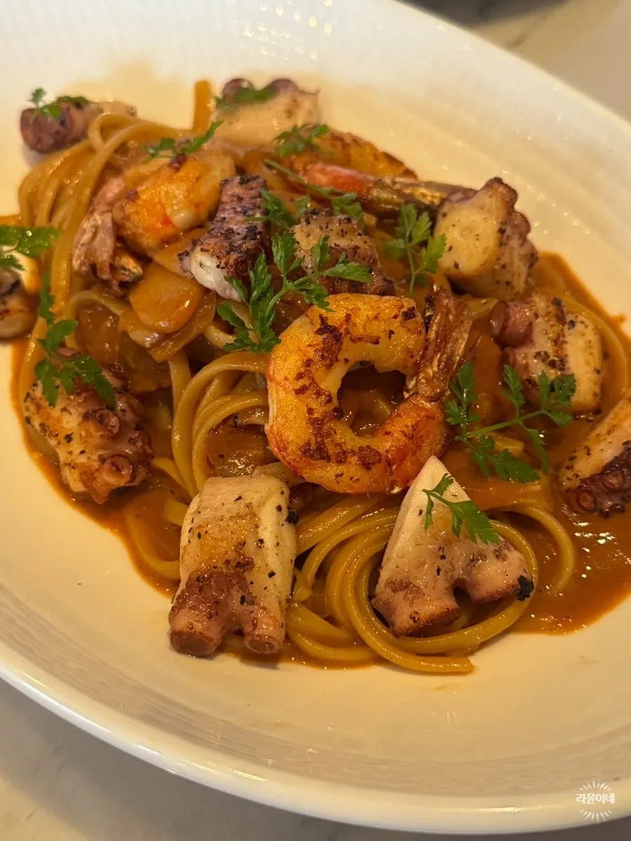 Bisque linguine topped with red shrimp, octopus, and squid