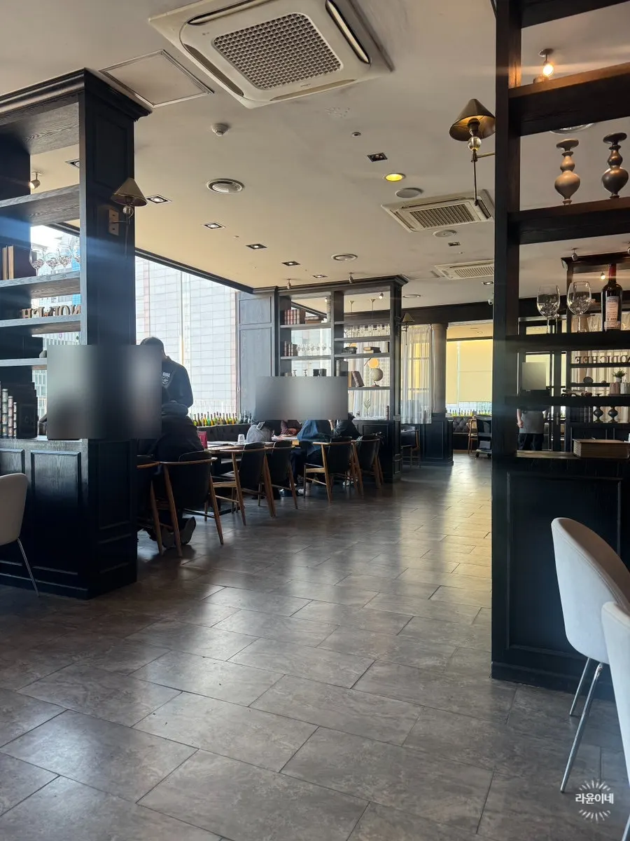 Restaurant interior with wine shelves acting as partitions