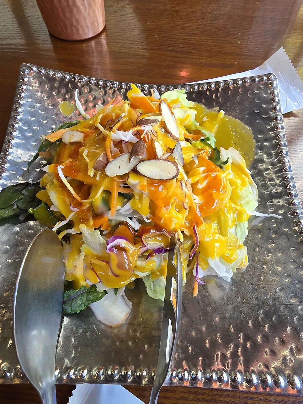 Onion salad and pickles served on Indian-style dishware