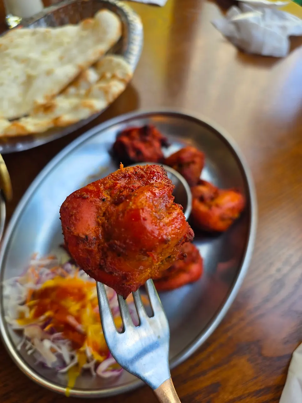Plate of tandoori chicken paired with garlic naan