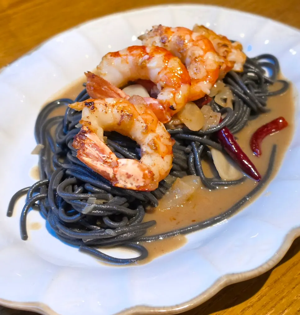 Red shrimp aglio e olio pasta made with squid ink noodles