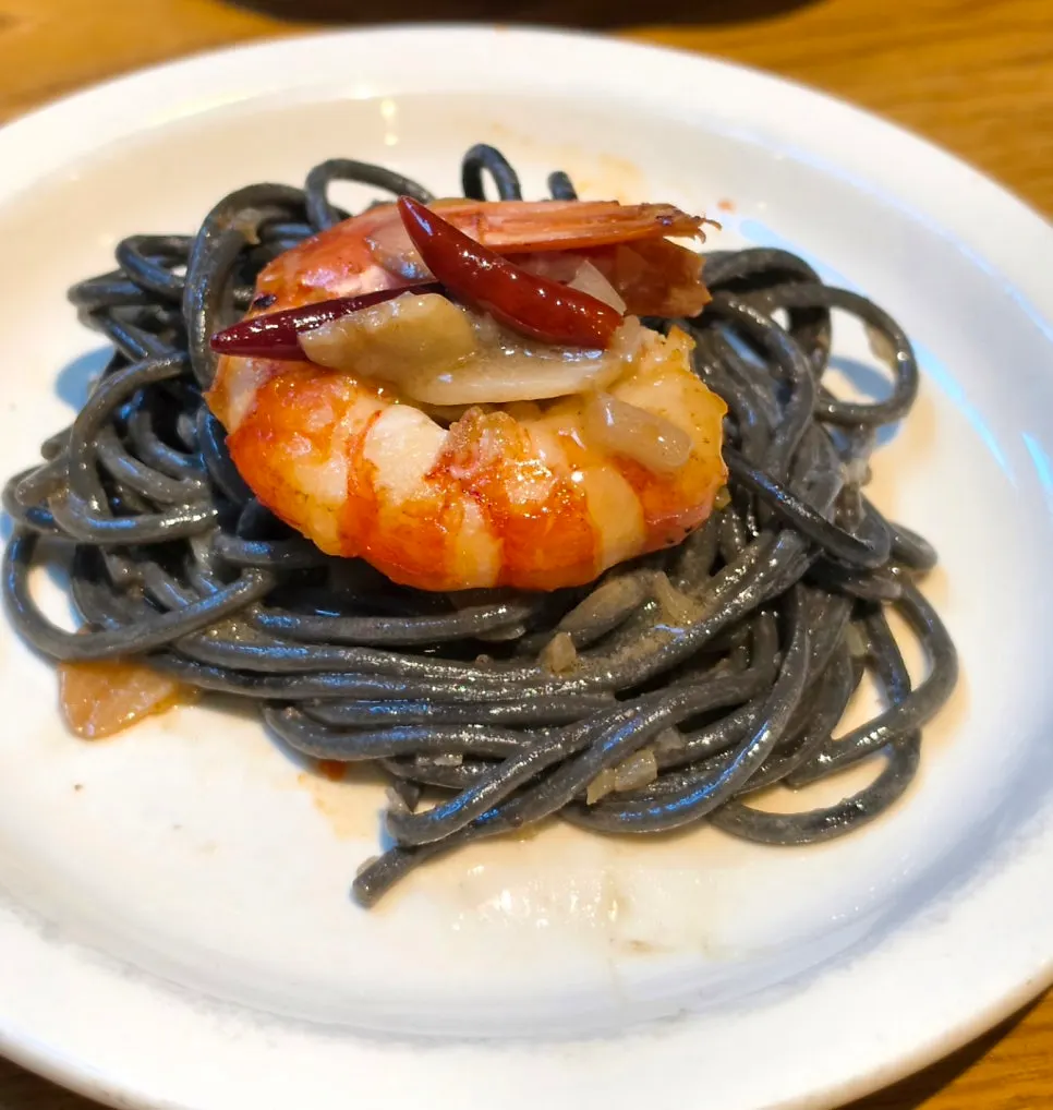 Garlic and pepperoncino visible in the ink pasta