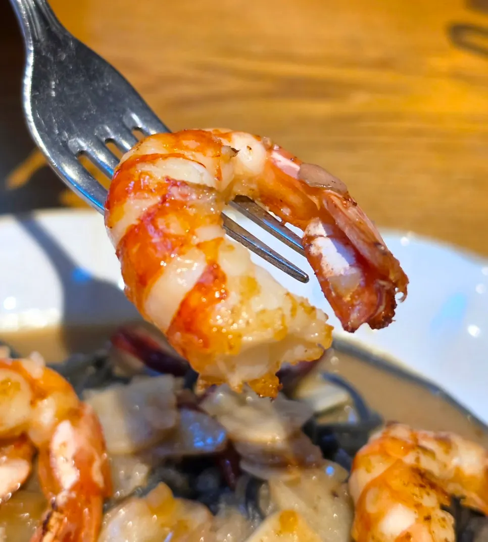 Picking up a plump red shrimp
