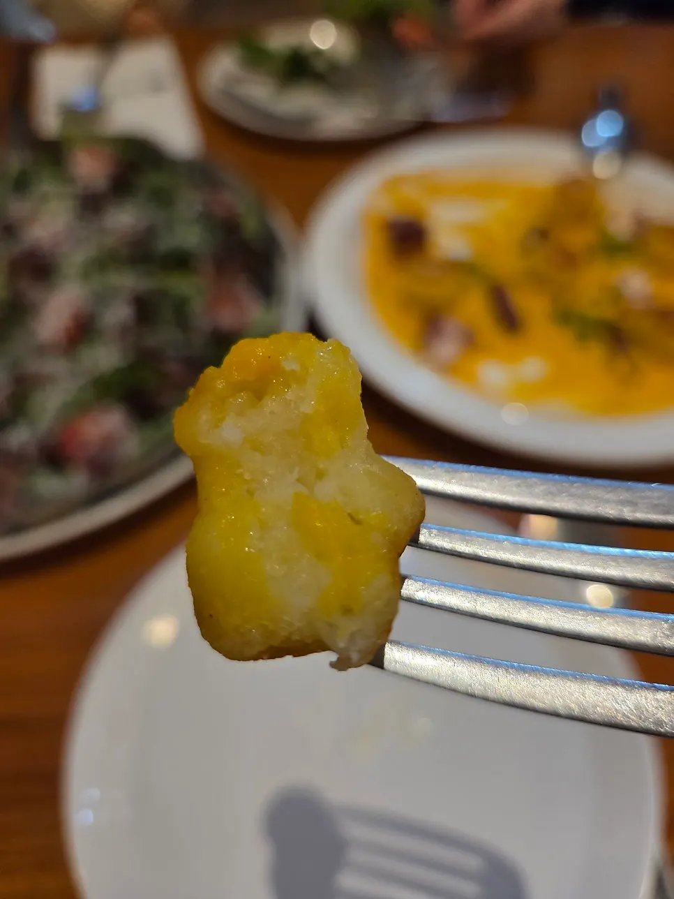 Gnocchi and octopus on yellow carrot purée