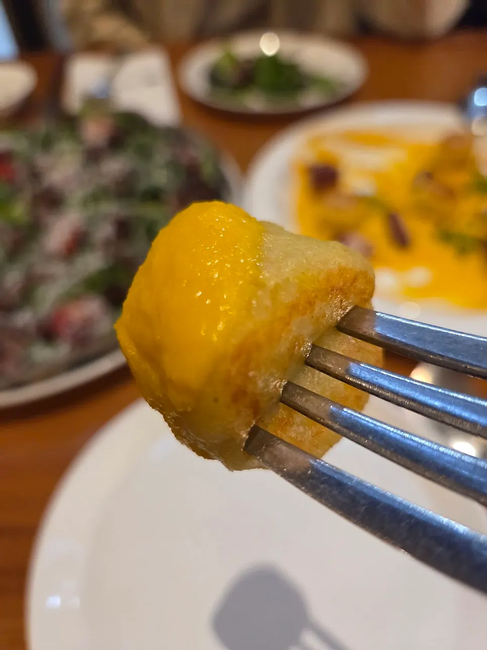 A chewy piece of gnocchi coated in purée